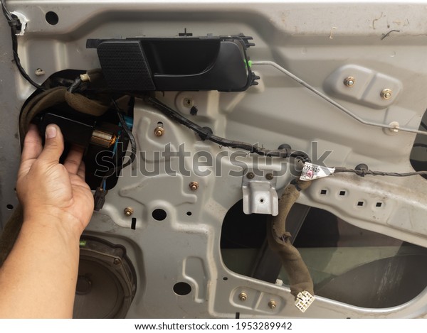 man hands repairing or\
disassembling electric motor of car door or truck professional\
work