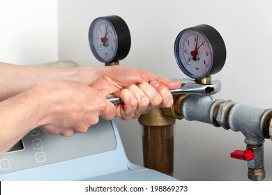 Man hands repairing pressure gauge and valve