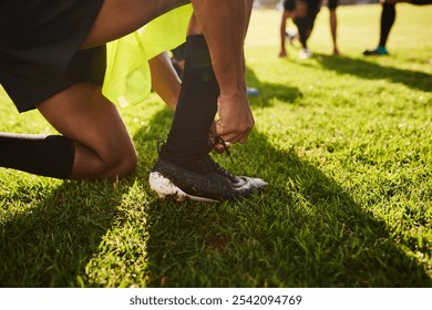 Man, hands or rugby player with tying lace on grass field for training preparation, game or outdoor match. Closeup, male person or getting ready with tie shoe for football sport or practice in nature - Powered by Shutterstock