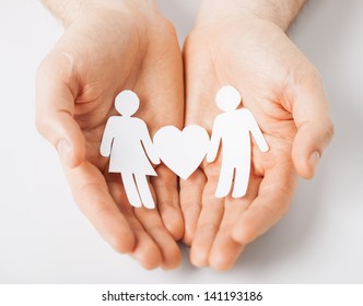 man hands showing two paper men with heart shape - Shutterstock ID 141193186