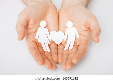 man hands showing two paper men with heart shape - Shutterstock ID 145691612