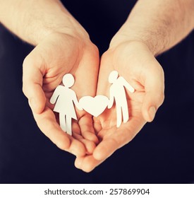 man hands showing two paper men with heart shape - Shutterstock ID 257869904