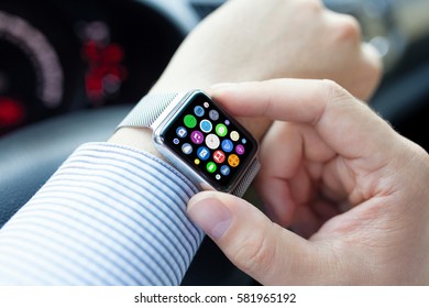Man hands and smart touch watch with home screen icons apps in car