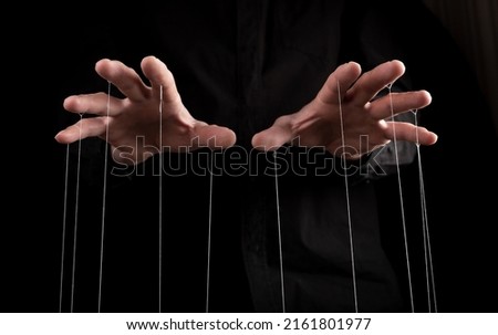Man hands with strings on fingers. Manipulation, negative influence or addiction concept. Becoming dependent on alcohol, drugs, gambling. High quality photo