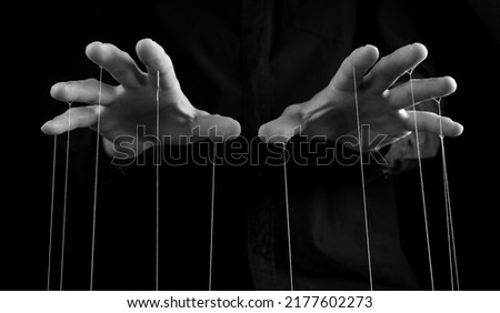 Man hands with strings on fingers. Negative abusive relationship, manipulation, control, power concept. Black and white. High quality photo