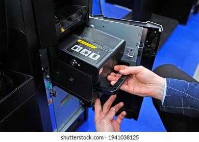 Man Hands Taking The Cash Cassette From The Cash Recycler.