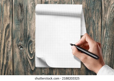 A Man Hands Is Trying To Drawing In A Notebook. Test For Essential Tremor And Parkinson's Disease.