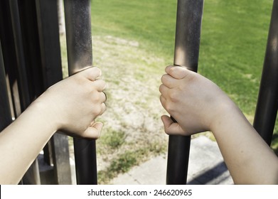 Man Hands Trying To Open A Prison Bars