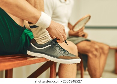 Man, hands and tying with shoes for fitness, training or getting ready in workout, exercise or game in locker room. Closeup of male person or sports player tie laces in preparation for match or play - Powered by Shutterstock