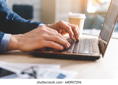 Man hands typing at laptop in room - Shutterstock ID 640907296