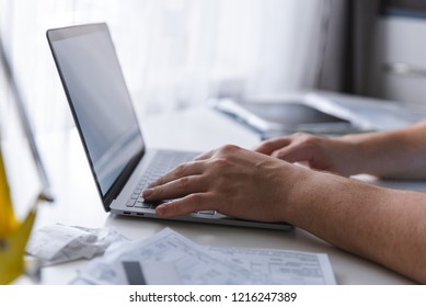 Man Hands Typing On Keyboard. Laptop With White Screen. Laptop Looks Like Macbook. Copy Space