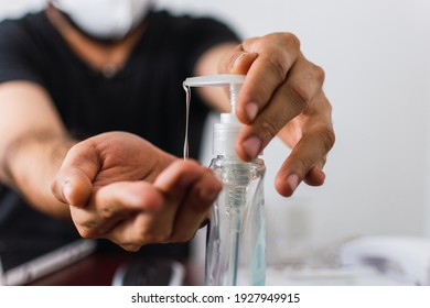 
Man hands use antibacterial gel close up