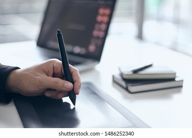 
man hands using digital tablet working touch up design