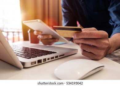 Man hands using laptop and holding credit card with social media as Online shopping concept in morning light - Shutterstock ID 534193042