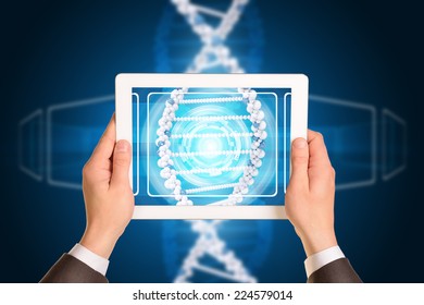 Man hands using tablet pc. Image of DNA helix on tablet screen - Powered by Shutterstock - Get 15% off with code: PIKWIZARD15