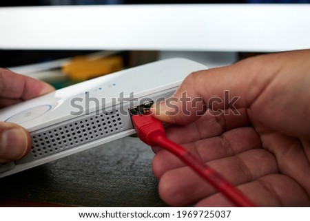 Man hands using a wifi repeater to extend network coverage