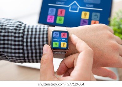 man hands with watch and notebook app smart home on screen 
