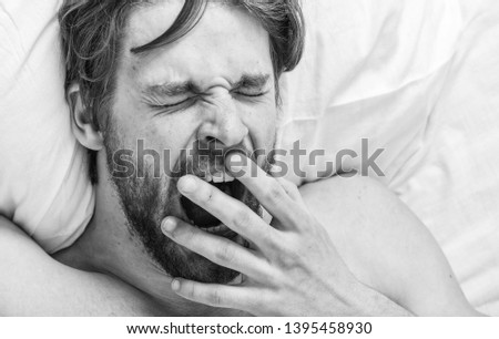 Man handsome guy lay in bed. Get adequate and consistent amount of sleep every night. How much sleep you actually need. Bearded man sleeping face relaxing on pillow. Expert tips on sleeping better.