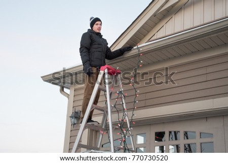  Man  Hanging  Christmas  Lights On Edge Stock Photo Edit Now 