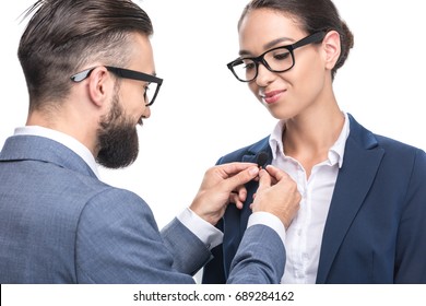 Man Hanging Tie Clip Microphone On Suit Of Colleague, Isolated On White 