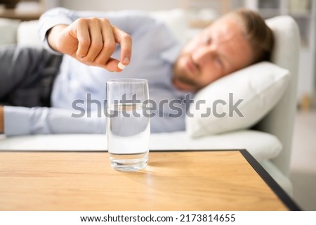 Man With Hangover Taking Medicine Pill Cure