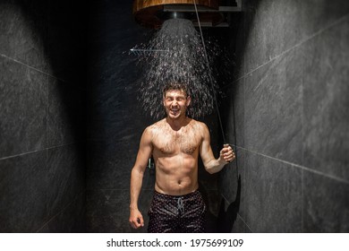 Man hardening with bucket of ice cold water after hot sauna, healthy lifestyle and cold training concept. Wellness and spa.