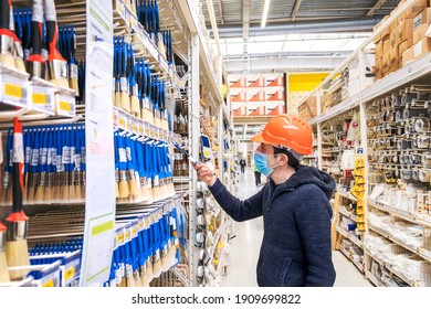 A Man In A Hardware Store. Sells Paint Brushes. Selective Focus. People.