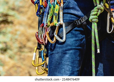 Man in harness and rockclimbing equipment