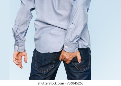 Man has Diarrhea Holding his Butt. Guy to hold with a hand a sore ass. Itching in the anus. Pain in the rectum due to cracks