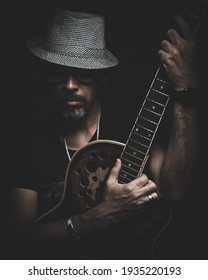 A man With a hat in the dark