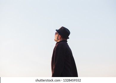 Man with hat looking at sky