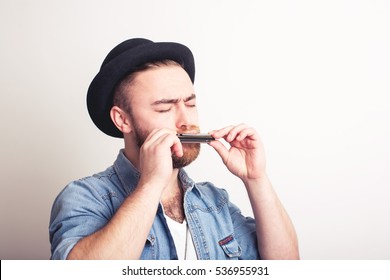 Man In Hat Playing On Harmonica