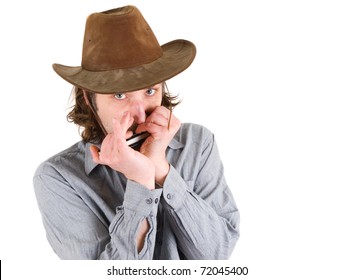 Man in Hat plays the harmonica