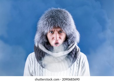 A Man In A Hat And Scarf Exhales Steam From His Mouth. Coldly. Warmly. Winter Time. Cold Weather.