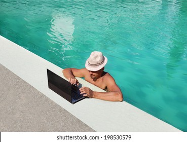 man in the hat works poolside - Powered by Shutterstock