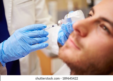 Man Having Botox Treatment At Beauty Clinic