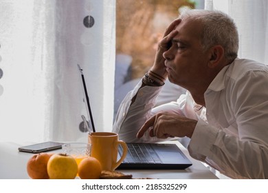 man having breakfast and depressive or bored in front of the laptop