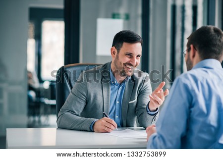 Man having a business meeting and signing a contract, recruitment or agreement.