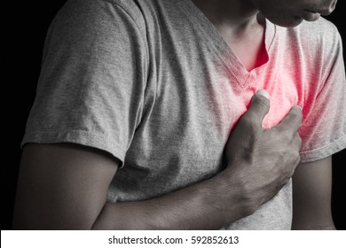 Man having chest pain, heart attack. - Shutterstock ID 592852613
