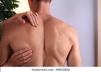 Man Having Chiropractic Back Adjustment Close Up. Osteopathy, Alternative Medicine, Pain Relief Concept