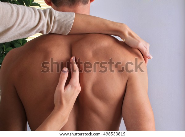 Man having\
chiropractic back adjustment close up. Osteopathy, Alternative\
medicine, pain relief\
concept