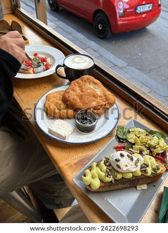 man having delicious huge breakfast at cool restaurant or cafe, avocado on top of rye bread toast, ready to indulge and fullfill hunger, fried  pie. 