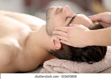 Man Having Face Massage In Spa Salon