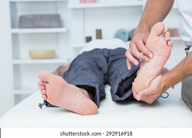 Man having foot massage in medical office