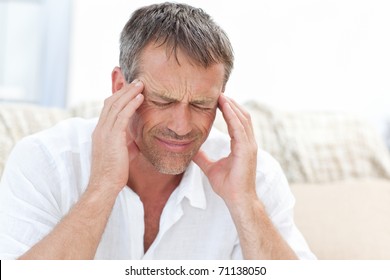 Man Having A Headache At Home