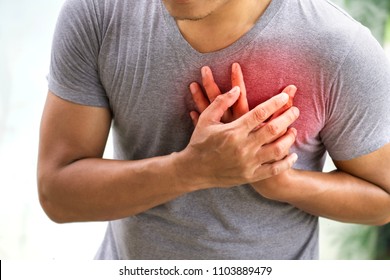 man having heart attack. healthcare concept - Shutterstock ID 1103889479
