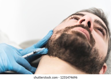 Man Having Jaw Filler Injections At Medical Clinic. Space For Text.