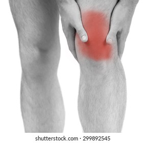 Man Having Knee Pain, Studio Shot Over White Background. Close-up. Black And White Photo.