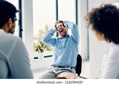 A Man Having Mental Burnout At Group Psycho Therapy.