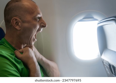 Man having panic attack  on airplane interior background. man and anxiety with burnout, depression and panic attack at aircraft seat. suffering social anxiety attack in public transport, concept